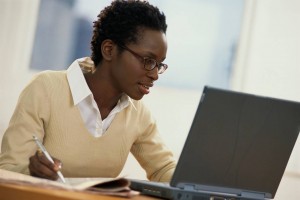 Black woman studying at a computer