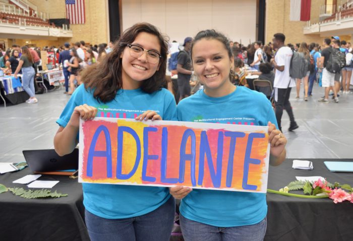 image of two students holding sign