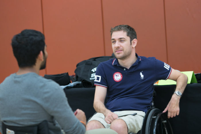 image of student speaking with athlete