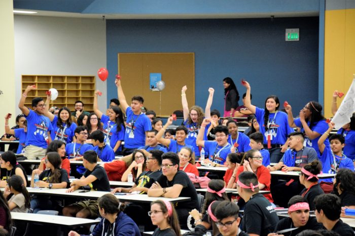 Image of students in blue shirts at Great Debate