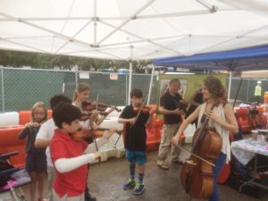 Kids playing violins.