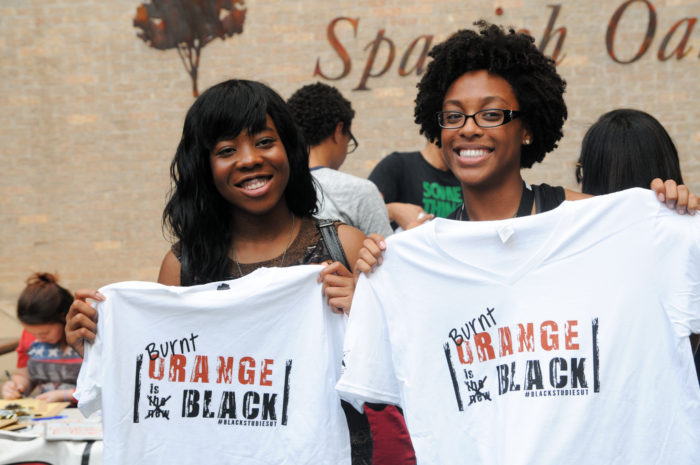 Image of Black students holding t-shirts