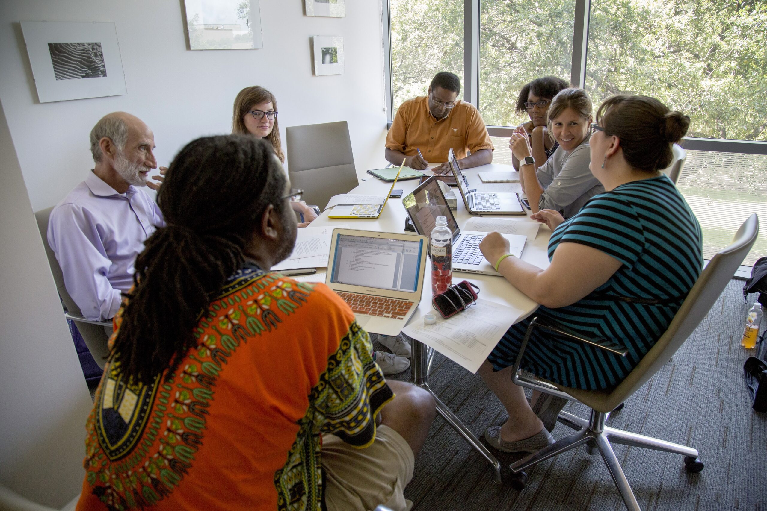 Group of faculty in an office discussion around a table