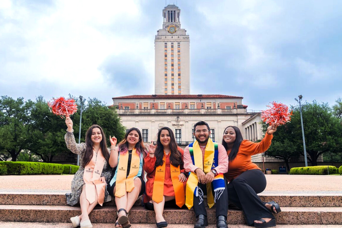 Impact Scholars sitting on steps in front of UT Tower