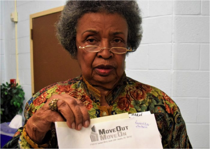 Longtime East Austin resident Bettye Washington holds up a letter from a business vying to purchase her home. Move out and move on. That’s the message Bettye Washington receives on a routine basis at her small shotgun house in East Austin. But no matter how many propositions she gets from buyers, she is staying put.