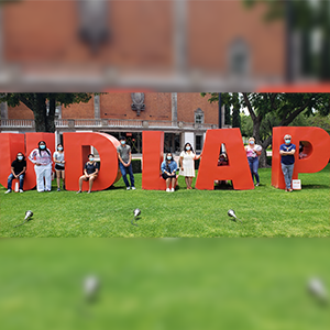 Students standing with Puebla UDLAP Sign