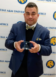 Dr. Fuentes holding award