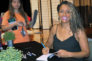 Thais Moore signing books at her book release